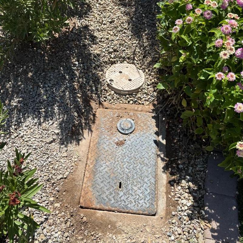 Pressure relief valve with tan access box at water meter