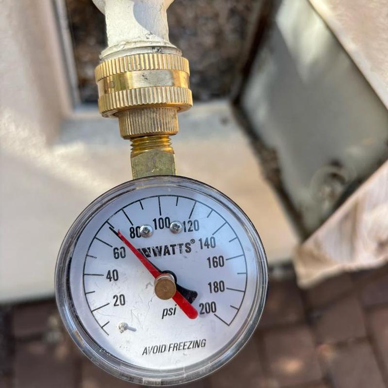 Pressure relief valve gauge reading 75 psi near water meter