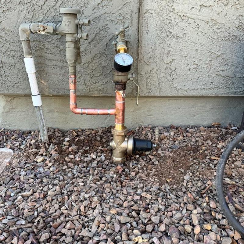 Pressure reducing valve with gauge installed on copper pipe