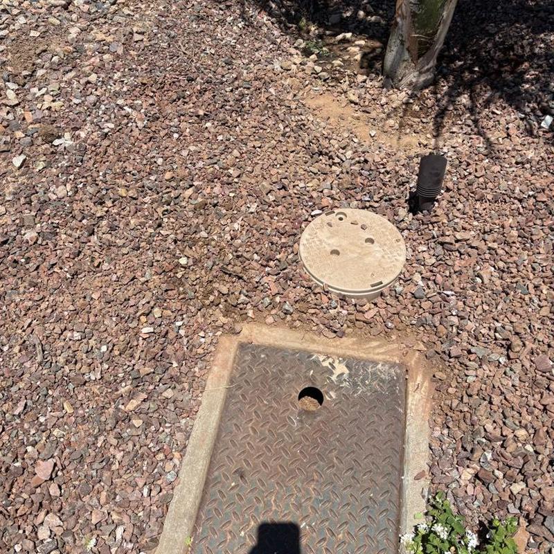 Pressure relief valve with tan access box near water meter