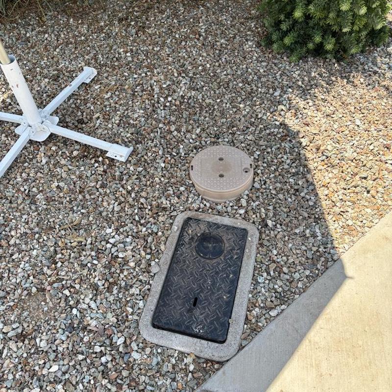 Pressure relief valve with tan access box near water meter