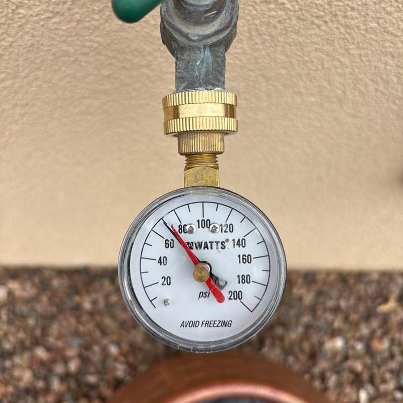 Water pressure gauge showing 80 psi near meter