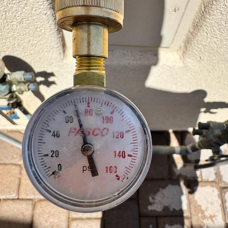 Pressure gauge on water main measuring PSI at 80-85