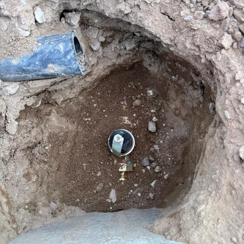 Water main valve and access box installation in dirt pit