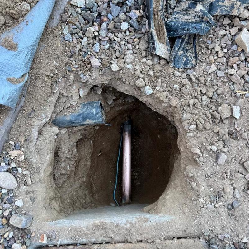 Copper water main access with PRV installation in dirt hole