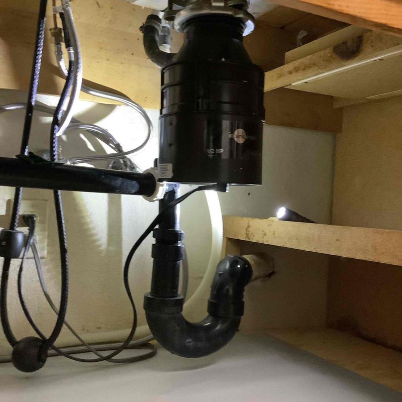 Garbage disposal unit with drain pipe installation under sink