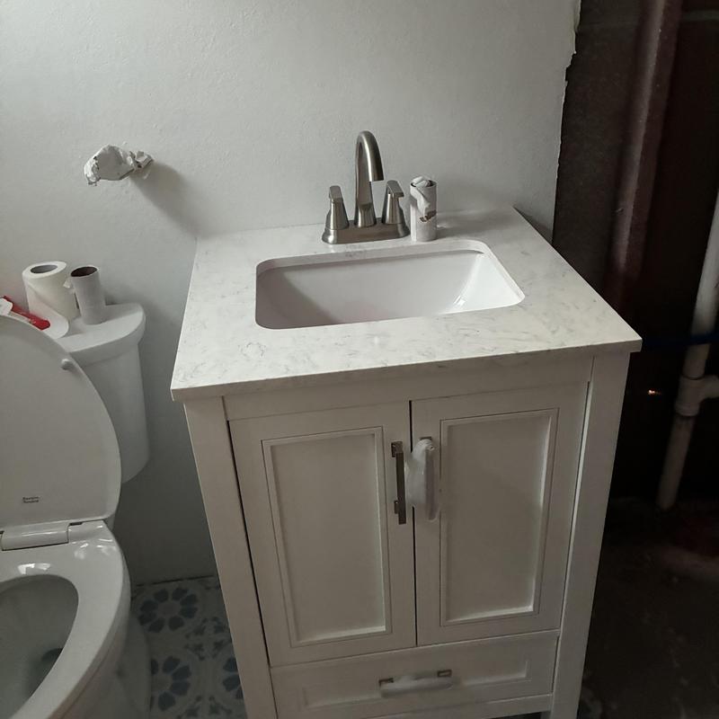 Bathroom sink vanity with faucet and countertop installed