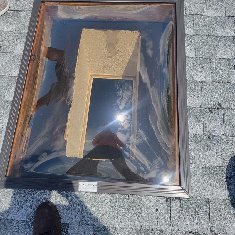 Skylight with cracked seal on shingle roof Skylight with cracked seal on shingle roof