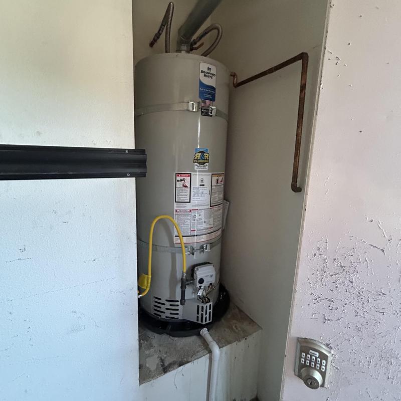 Water heater with new gas line and sediment trap