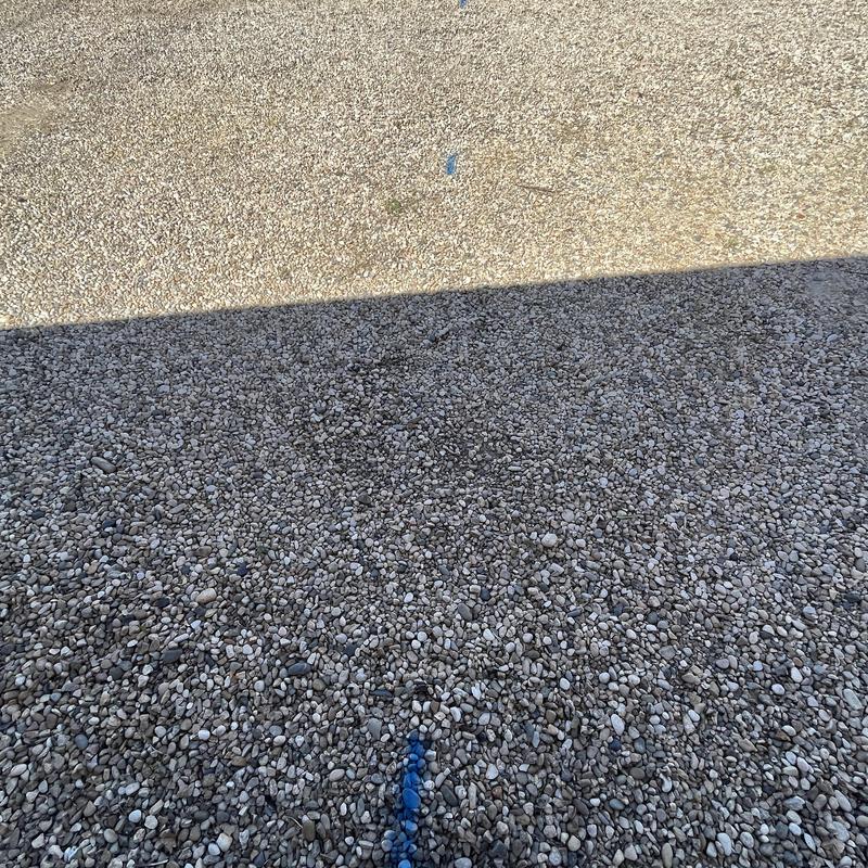 Watermain trench marked on gravel surface for replacement