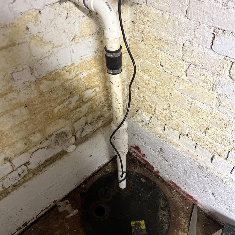 Zoeller sump pump system in basement corner