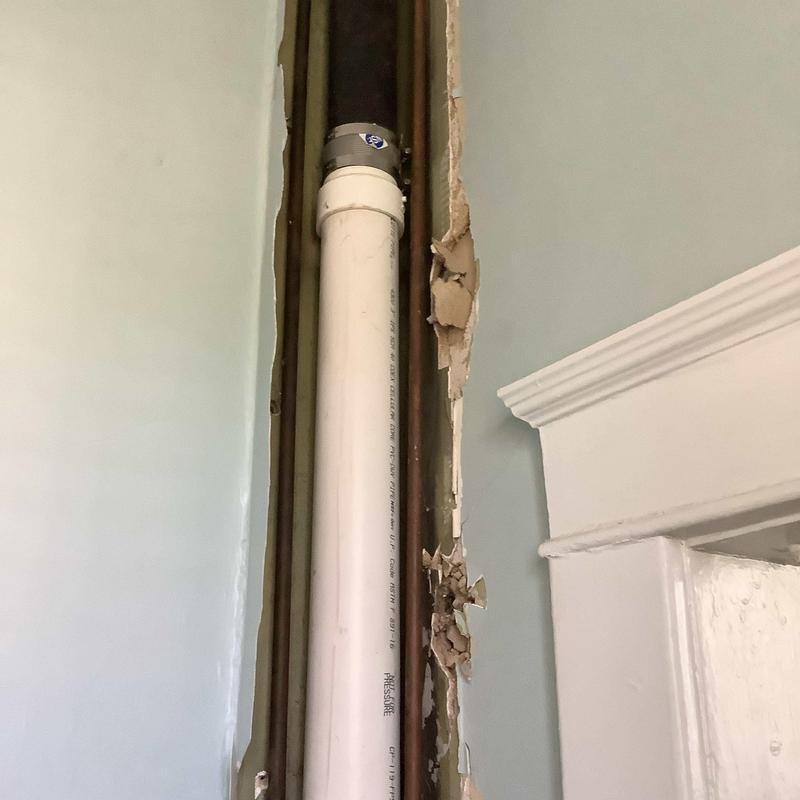 PVC drain line inside home wall with drywall removed PVC drain line inside home wall with drywall removed