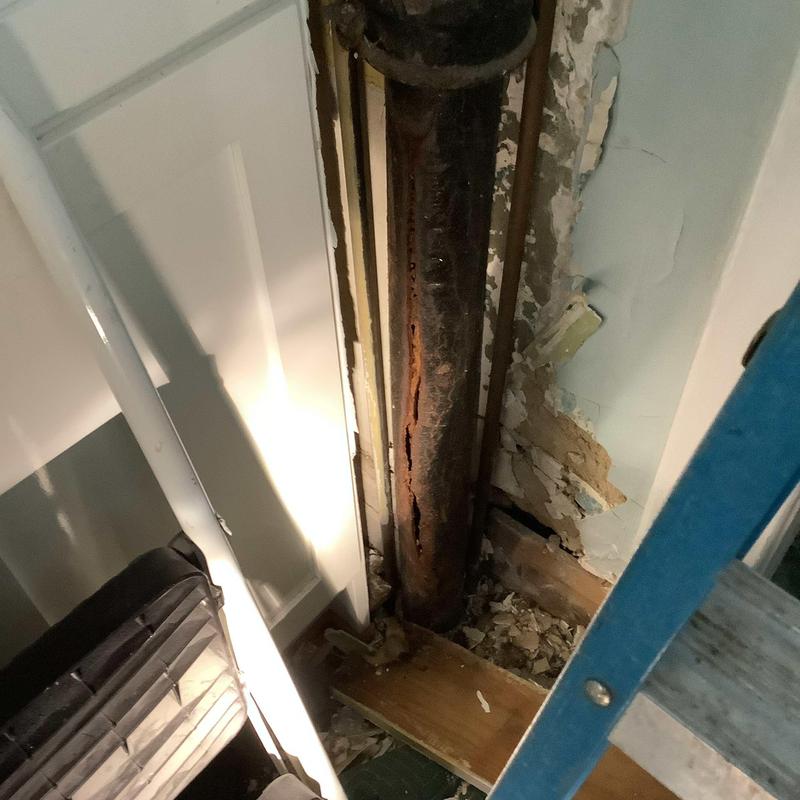 Cracked cast iron drain pipe inside wall exposed Cracked cast iron drain pipe inside wall exposed