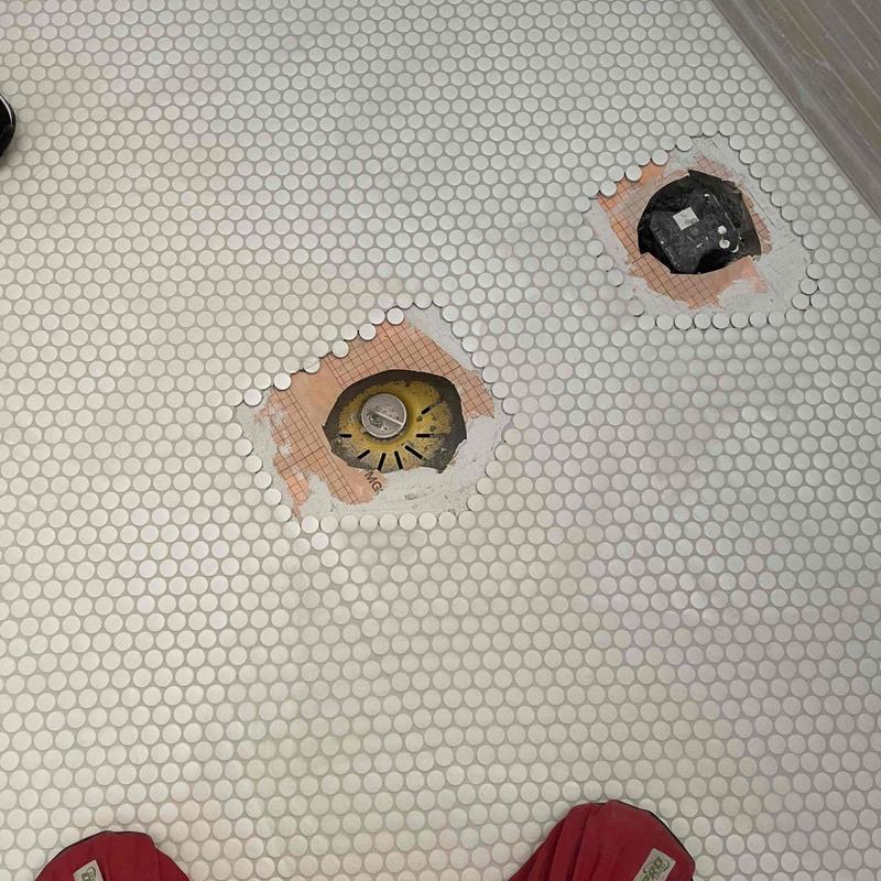Bathroom floor drain and toilet flange installation cuts