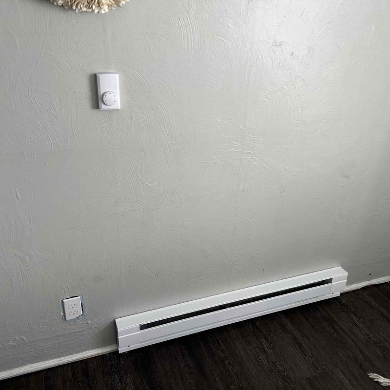 Electric baseboard heater with thermostat and outlet