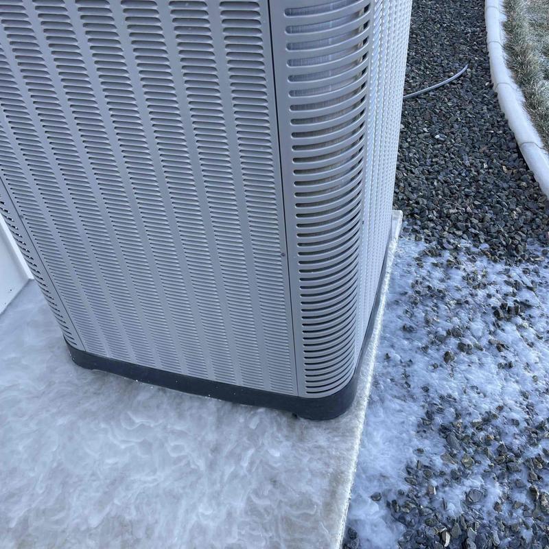 Air conditioner unit on concrete pad with gravel edge Air conditioner unit on concrete pad with gravel edge