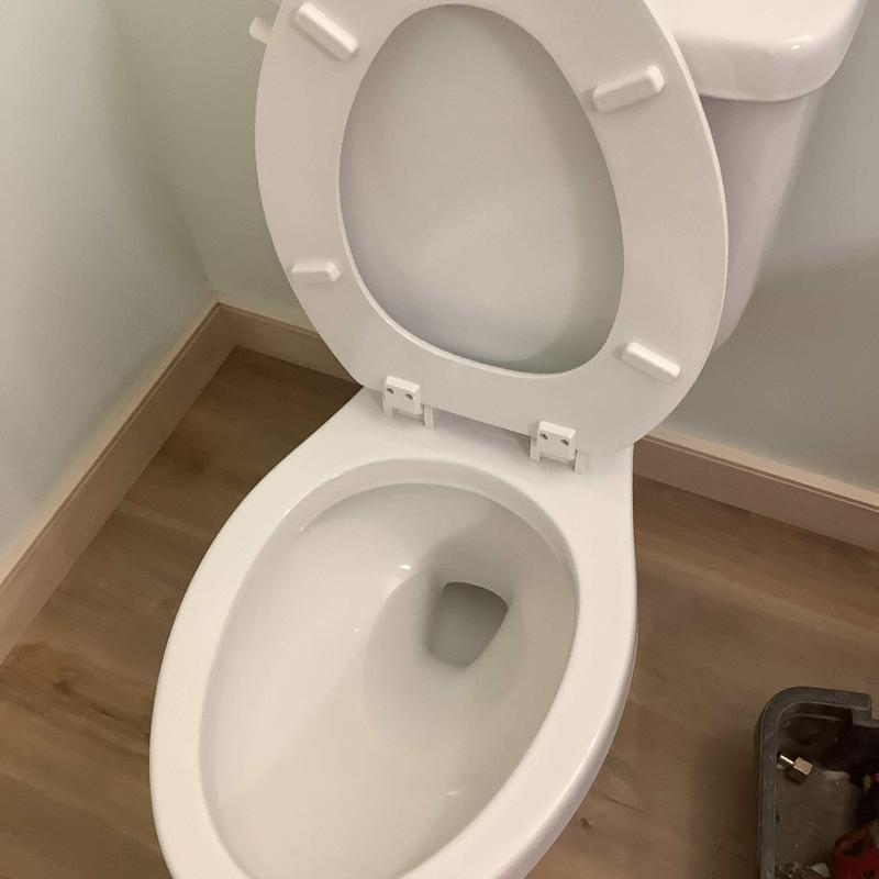 Toilet bowl and seat installed in home workshop Toilet bowl and seat installed in home workshop