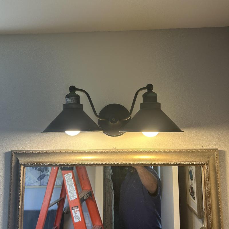 Vanity light fixture installed above bathroom mirror