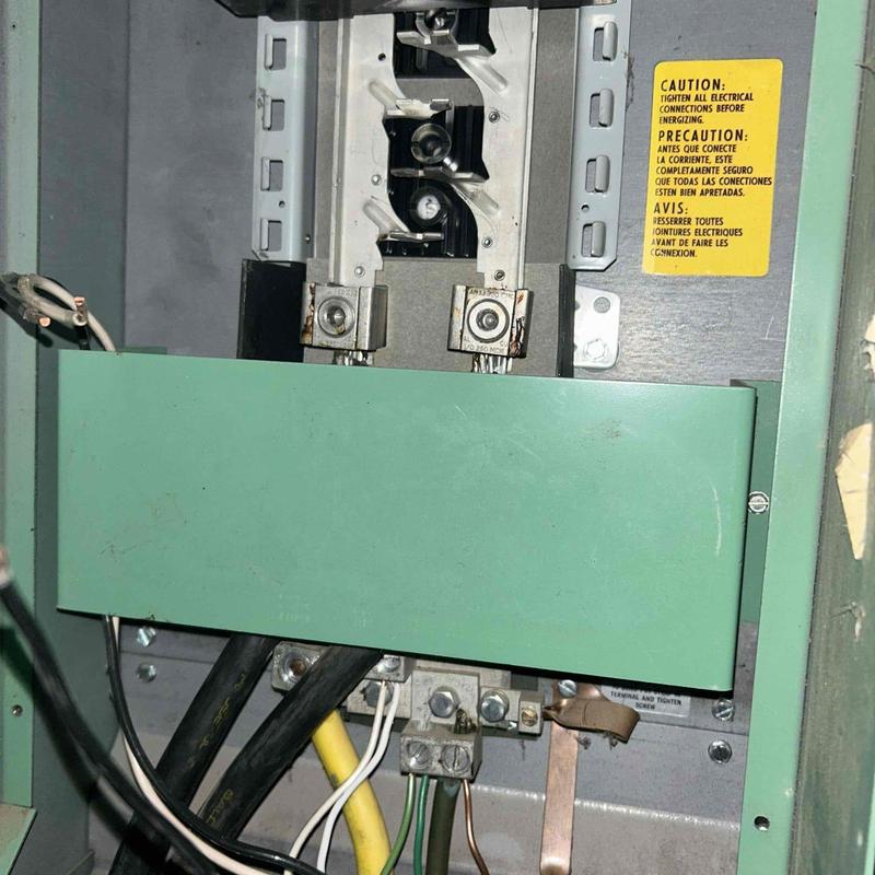 Main electrical breaker panel with open cover and wiring