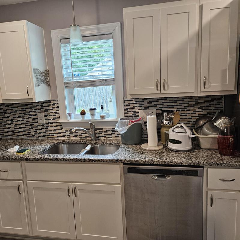 Kitchen faucet and granite countertop with backsplash