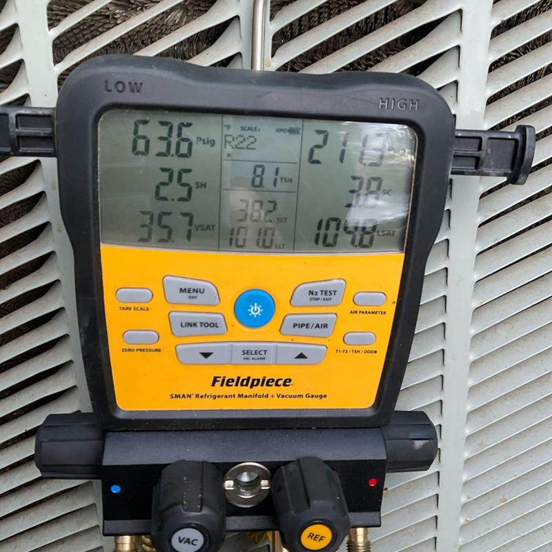 Refrigerant manifold gauge on HVAC unit pressure check
