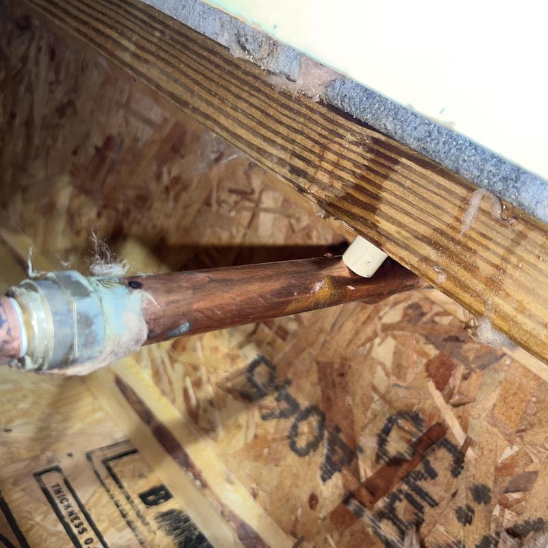 Copper pipe with plastic insert fitting under floor joist Copper pipe with plastic insert fitting under floor joist