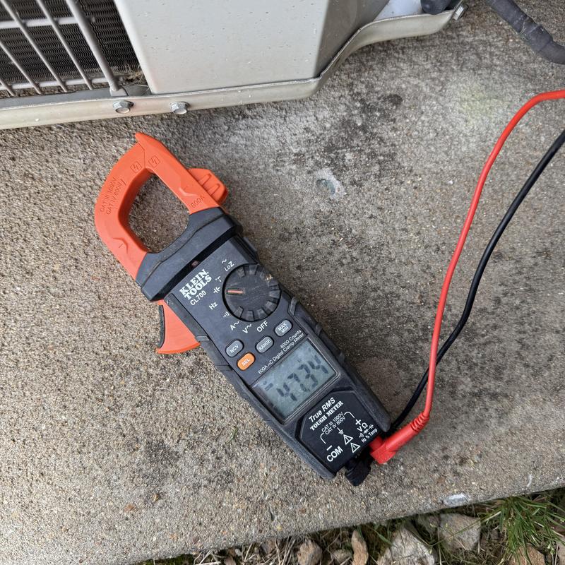 Clamp meter measuring HVAC unit electrical current Clamp meter measuring HVAC unit electrical current