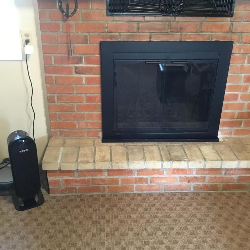 Gas fireplace insert with black metal frame