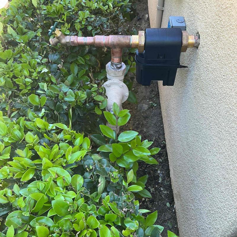 Moen Flo device on main water riser outside garage