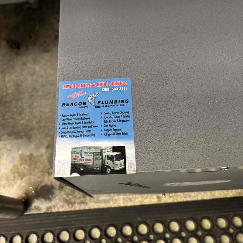 Boiler unit with Beacon Plumbing service sticker