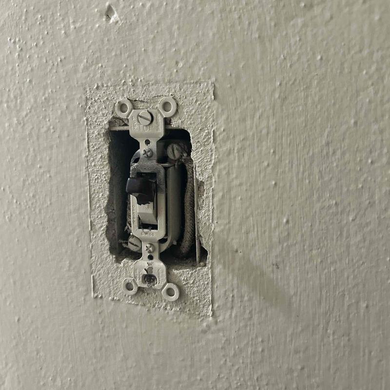 Wall light switch with capped off wires in drywall