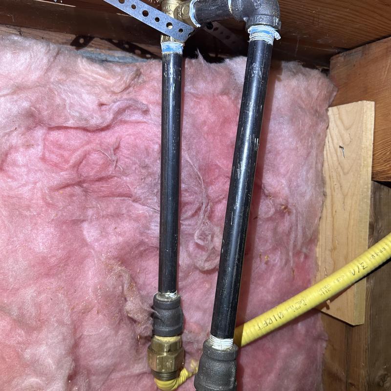 Gas valve and black pipe installation with insulation background