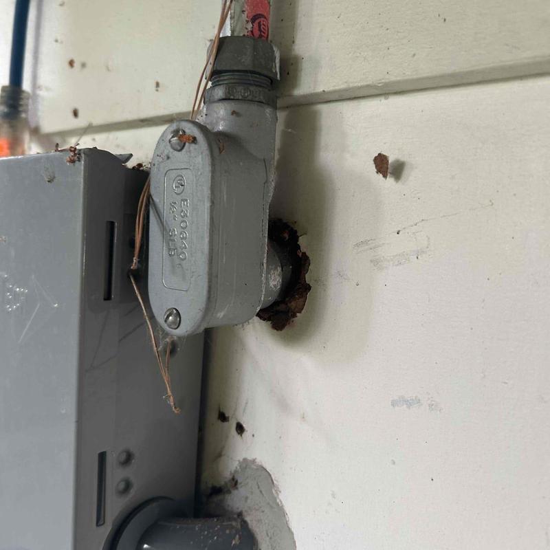 Electrical conduit with rust damage on wall mount