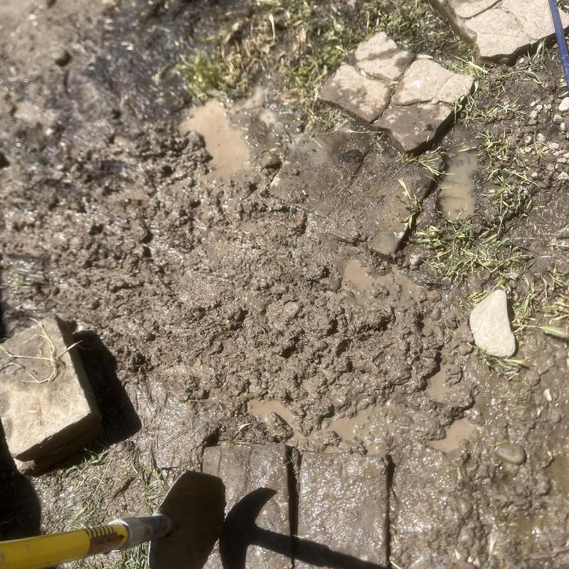 Irrigation piping leak with muddy water and pavers removed