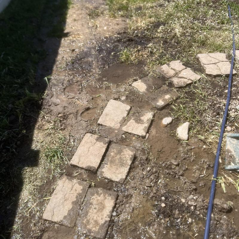 Irrigation pipe leak with water bubbling under pavers