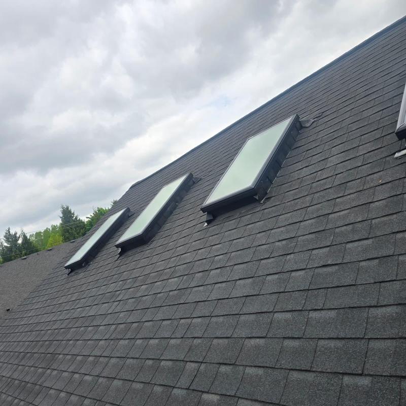 Skylight windows on black shingle roof