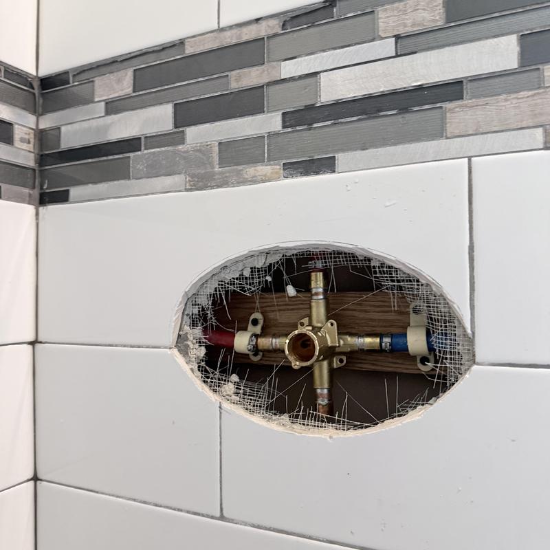 Shower valve plumbing with hot and cold lines visible Shower valve plumbing with hot and cold lines visible