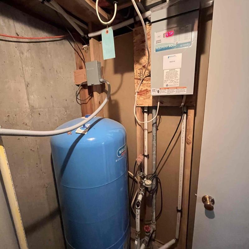 Well pressure tank and water line installation in basement