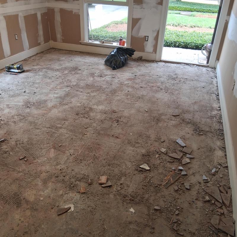 Hardwood flooring demo with debris on subfloor