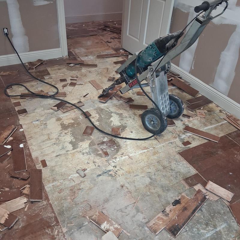 Hardwood flooring removal with demolition equipment