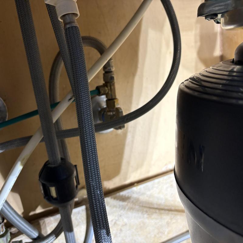 Garbage disposal and braided water supply lines under sink Garbage disposal and braided water supply lines under sink