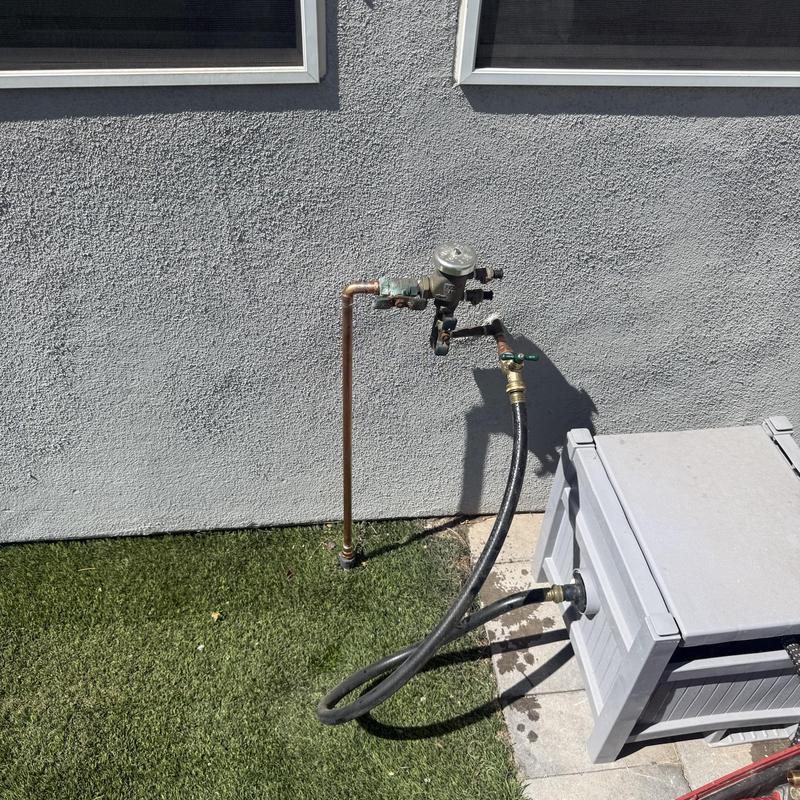 Outdoor hose bib with attached water meter and hose Outdoor hose bib with attached water meter and hose