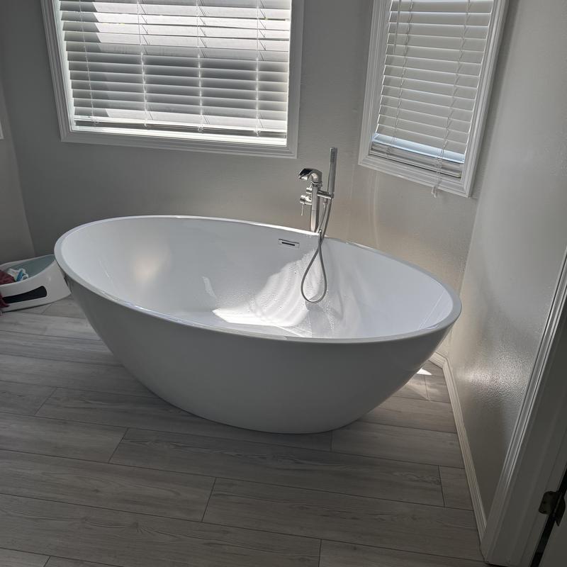 Freestanding bathtub with unsecured base and faucet