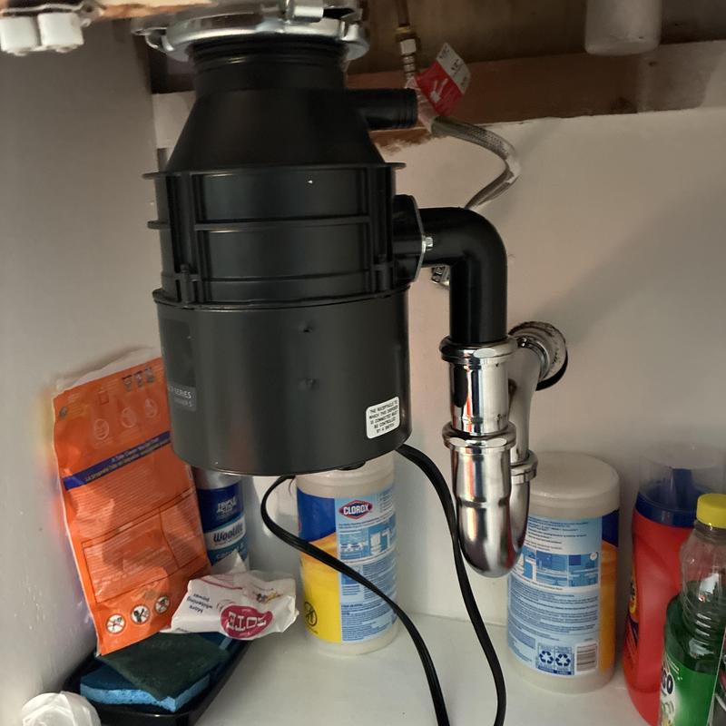 Garbage disposal and P-trap installation under kitchen sink Garbage disposal and P-trap installation under kitchen sink