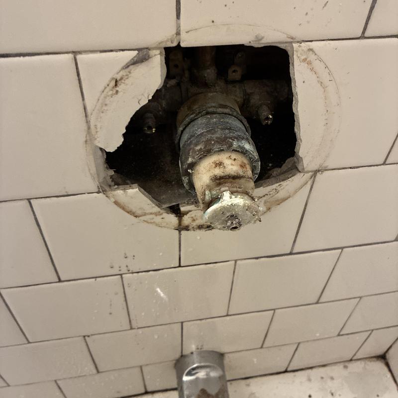 Delta shower faucet cartridge and valve stem exposed in tile wall Delta shower faucet cartridge and valve stem exposed in tile wall