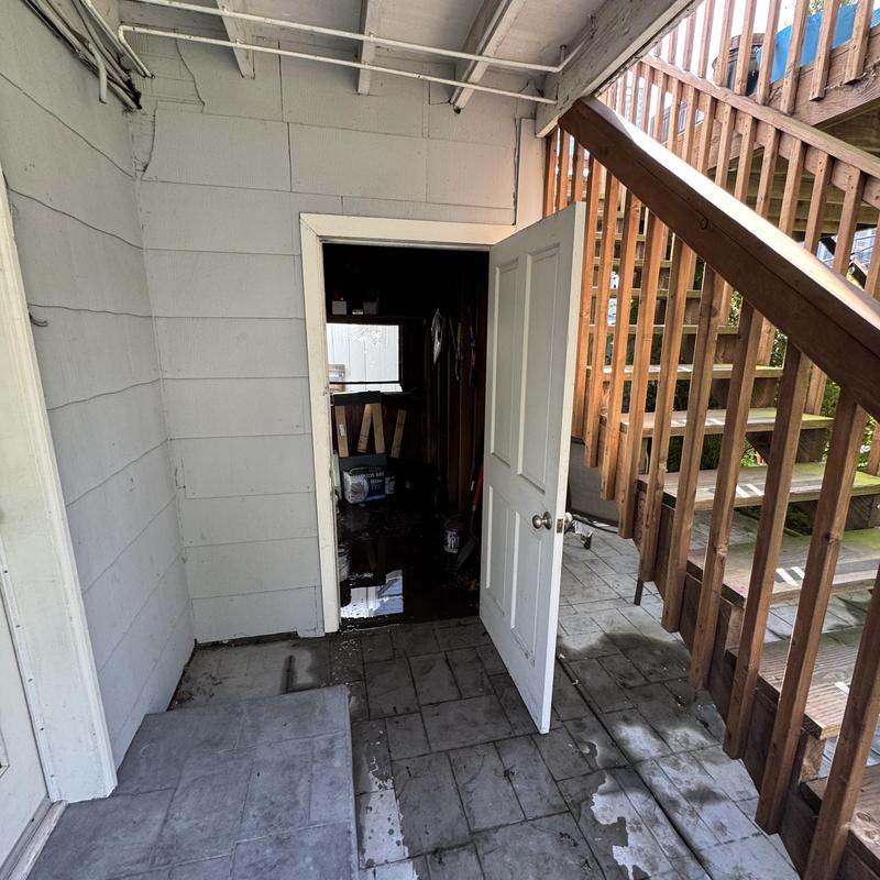 Water heater room under staircase with tiled floor Water heater room under staircase with tiled floor