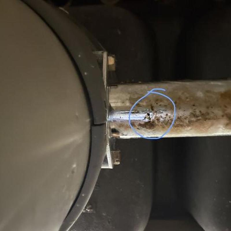 Drain tailpiece with corrosion damage circled in blue Drain tailpiece with corrosion damage circled in blue