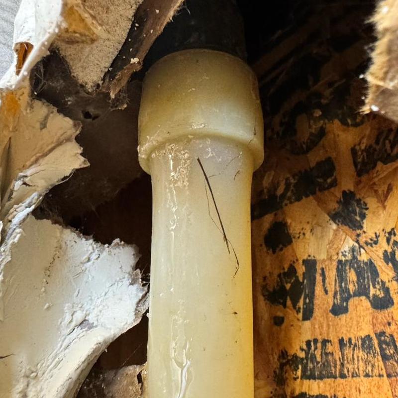 PEX pipe water leak with drywall damage inside wall cavity