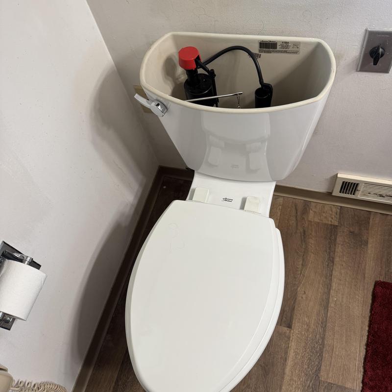 Toilet tank with flush valve and sealed lid installed