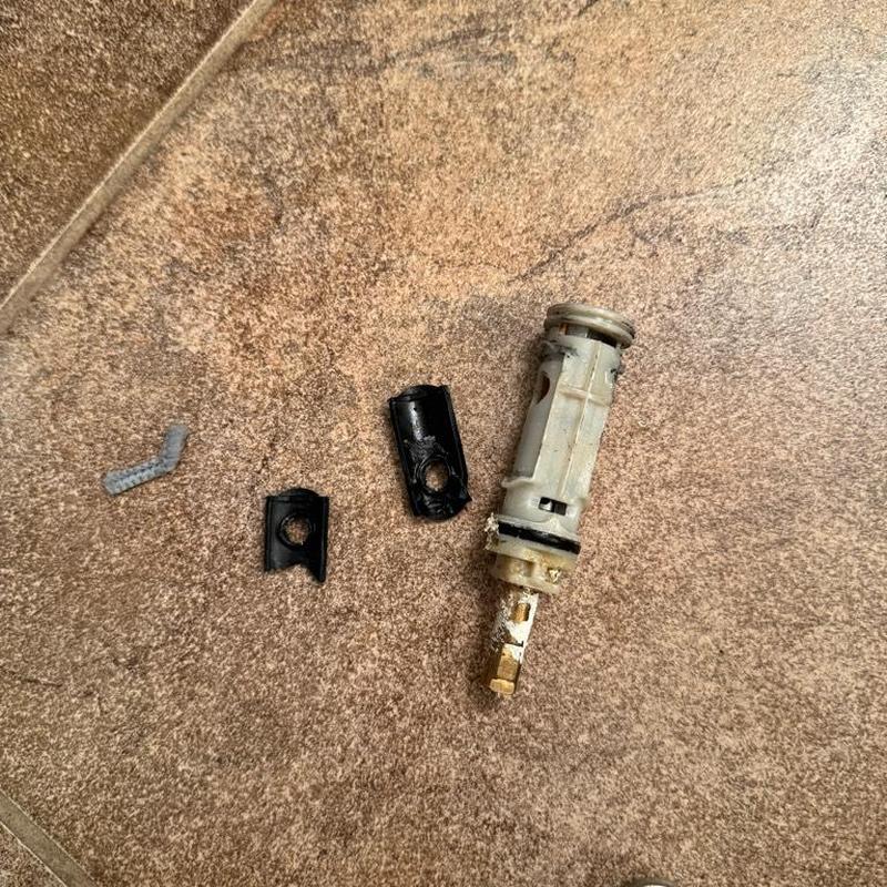 Moen shower cartridge and broken stem parts on floor